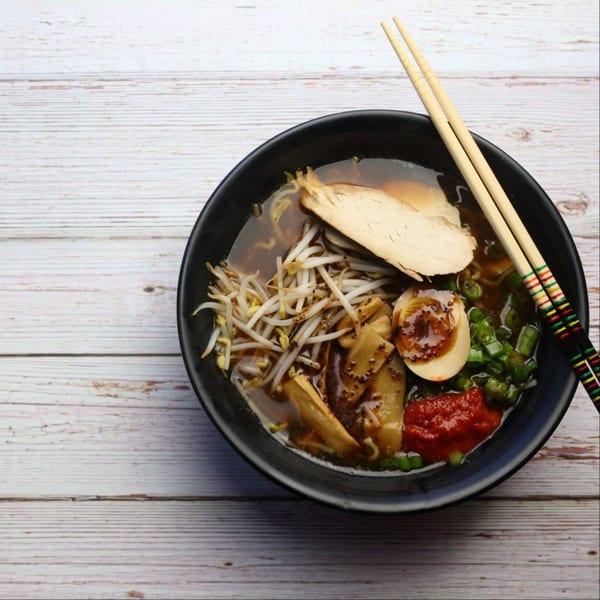 Yatai Ramen chicken ramen bowl with bean sprouts, egg, green onions, and red chili paste.